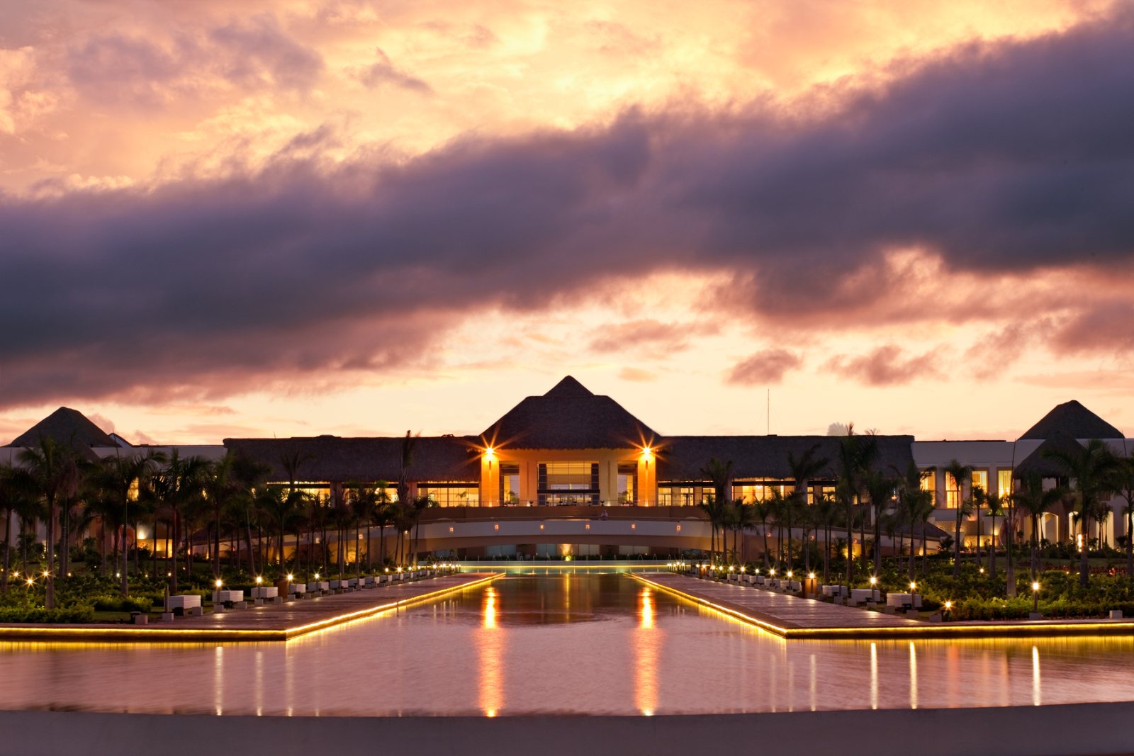 The grand exterior of Hard Rock Hotel & Casino Punta Cana glowing at sunset