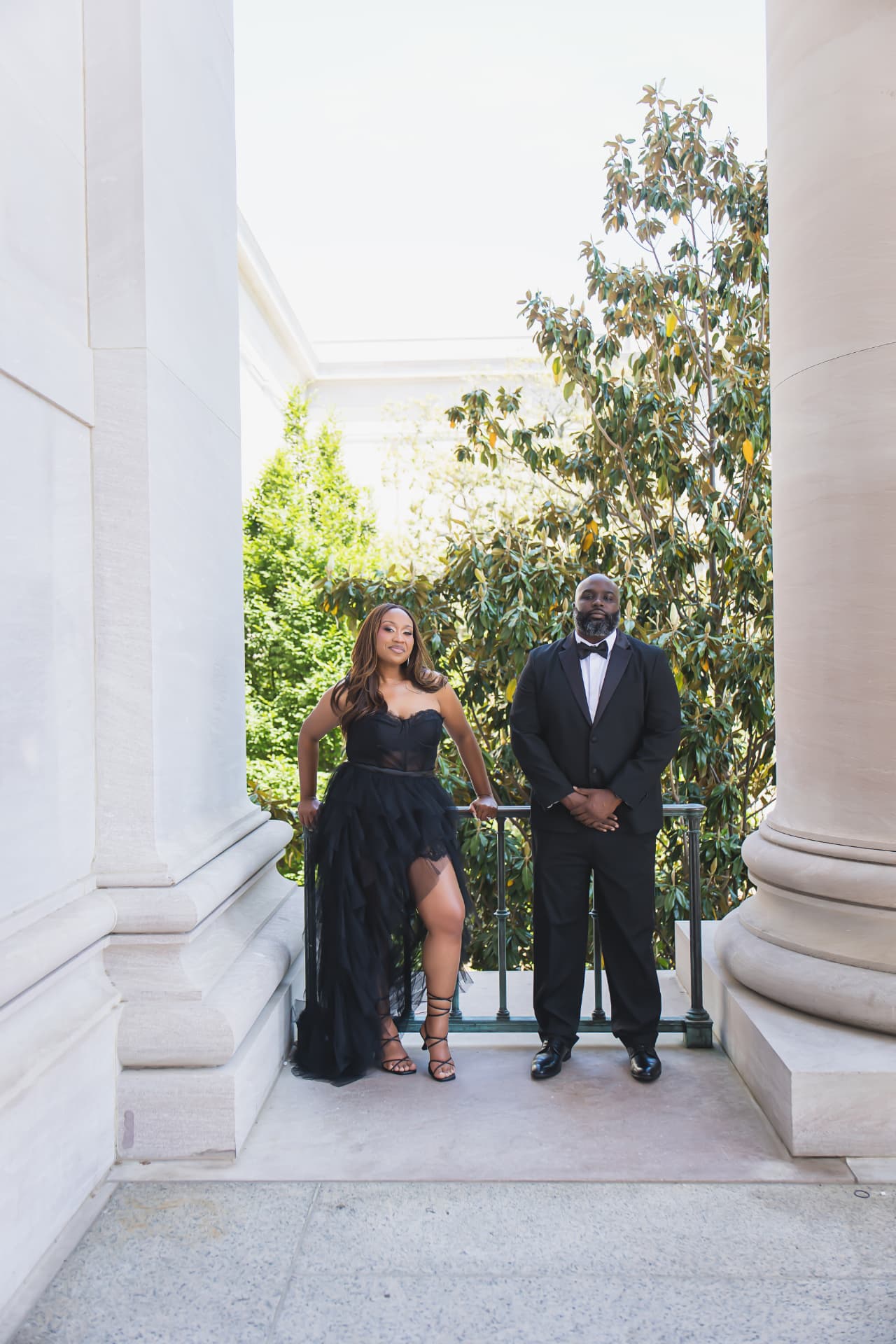 Jarron and Marissa standing together between marble columns